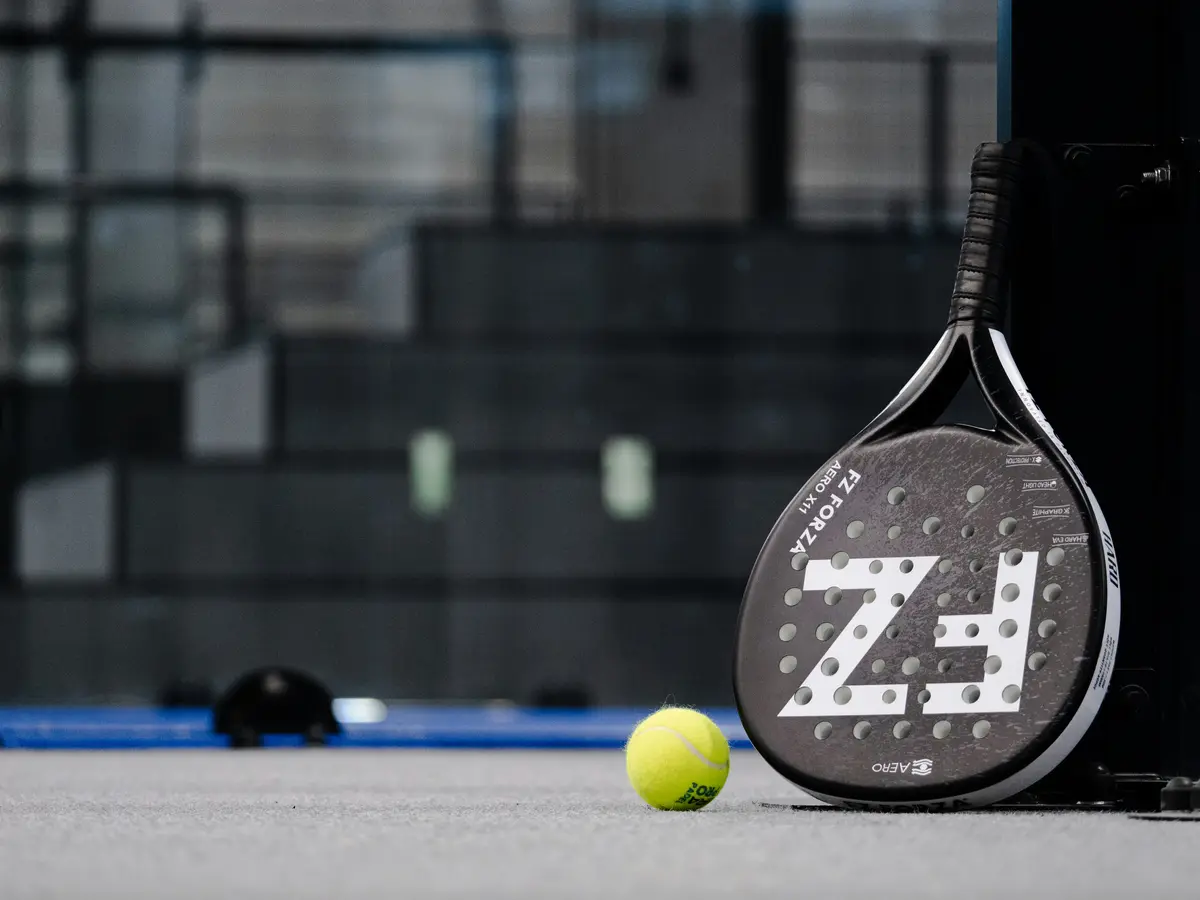 Padel racket and ball on the court