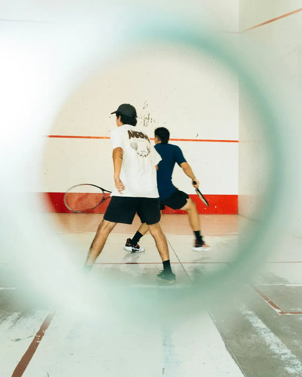Squash players on court between rallies